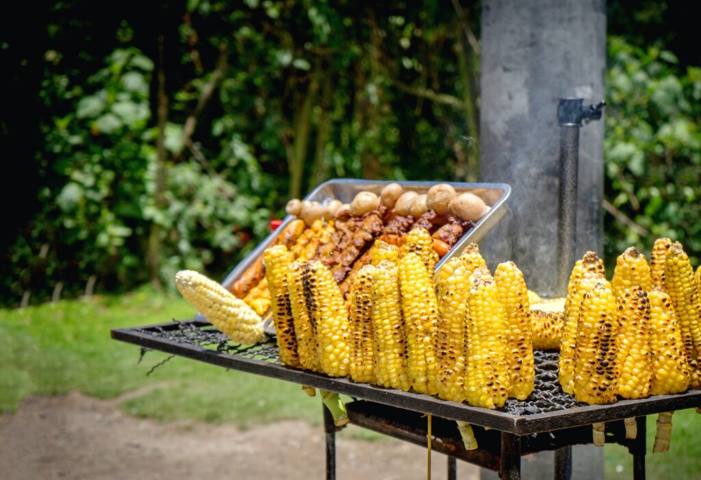 corn on the cob is being cooked on a grill